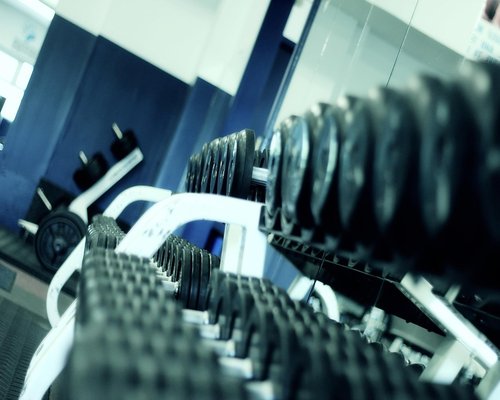 People using kettlebells and light weights in a fitness class