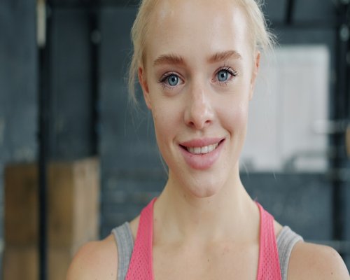 Portrait of a friendly gym instructor smiling in the workout area